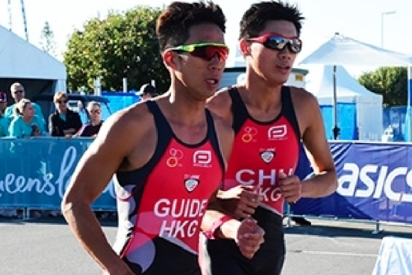 Two triathletes running side by side